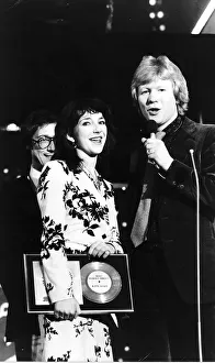 Pop singer Kate Bushholds her award as she stands with Radio 1 Disc Jockey David Kid Pop singer Kate Bushholds her award as she stands with Radio 1 Disc Jockey David Kid