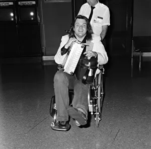 Pop singer Meat Loaf leaving Heathrow Airport in a wheelchair. 23rd June 1985 Pop singer Meat Loaf leaving Heathrow Airport in a wheelchair. 23rd June 1985