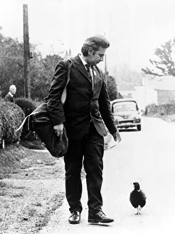 Postman Jim Burgess with the pheasant that follows him up the garden path Postman Jim Burgess with the pheasant that follows him up the garden path