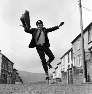 Postman Mr. Fred Henderson in happy mood as he delivers his mail. April 1975 Postman Mr. Fred Henderson in happy mood as he delivers his mail. April 1975