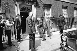 Prime Minister Edward Heath is rushed back inside Number 10 Downing Street watched by Prime Minister Edward Heath is rushed back inside Number 10 Downing Street watched by