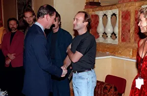 Prince Charles November 1992 shakes hands with musician Phil Collins as the rest of Prince Charles November 1992 shakes hands with musician Phil Collins as the rest of