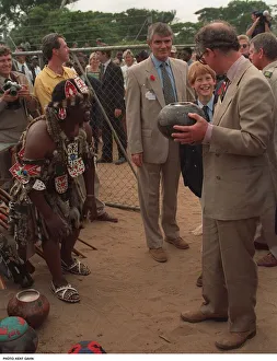 Prince Charles samples the native drink whilst his son Prince Harry watches on their Prince Charles samples the native drink whilst his son Prince Harry watches on their