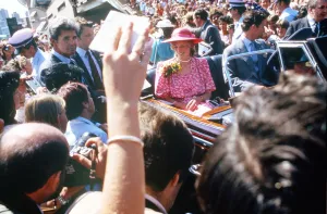 The Prince and Princess of Wales in a car driving through crowds of well wishers in front The Prince and Princess of Wales in a car driving through crowds of well wishers in front