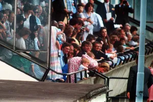 Princess Diana and Prince Harry lean over the railings to shout encouragement to Prince Princess Diana and Prince Harry lean over the railings to shout encouragement to Prince