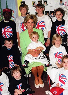 Princess Diana Princess of Wales with James Perry sitting on her knee during a visit to a Princess Diana Princess of Wales with James Perry sitting on her knee during a visit to a