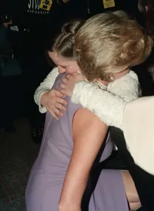 Princess Diana, wearing a purple dress, hugs Emma Jones at a Commonwealth Day luncheon in Princess Diana, wearing a purple dress, hugs Emma Jones at a Commonwealth Day luncheon in
