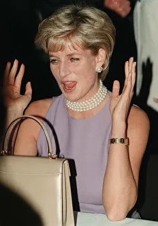 PRINCESS DIANA, WEARING A PURPLE DRESS AND NECKLACE LAUGHS AT AN EVENT HELD BY THE PRINCESS DIANA, WEARING A PURPLE DRESS AND NECKLACE LAUGHS AT AN EVENT HELD BY THE