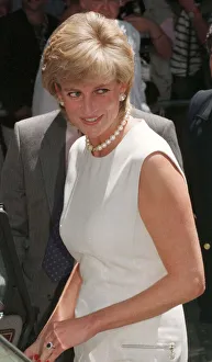 Princess Diana, wearing a white dress and necklace during a visit to a rehabilitation Princess Diana, wearing a white dress and necklace during a visit to a rehabilitation
