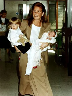 Princess Eugenie and Princess Beatrice being held by their mother the Duchess Of York at Princess Eugenie and Princess Beatrice being held by their mother the Duchess Of York at