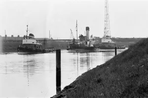 PS John H Amos, paddlewheel tugboat, built in Scotland in 1931, pictured going down river PS John H Amos, paddlewheel tugboat, built in Scotland in 1931, pictured going down river
