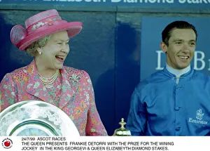 Queen Elizabeth presents Frankie Dettori with the prize for the winning jockey in Queen Elizabeth presents Frankie Dettori with the prize for the winning jockey in