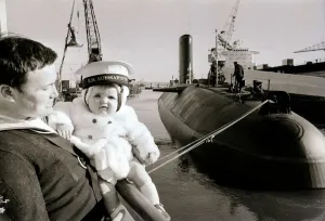 One of the ratings of the new submarine HMS Conqueror shows off his new ship to his son One of the ratings of the new submarine HMS Conqueror shows off his new ship to his son