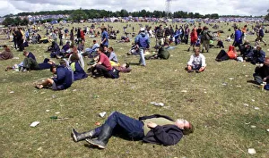 Revellers lying on the grass at Glastonbury Festival 1999 A©Mirrorpix Revellers lying on the grass at Glastonbury Festival 1999 A©Mirrorpix