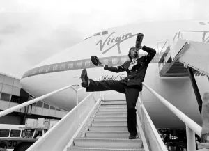 Richard Branson drinking from a bottle of champagne as he celebrates Virgin Atlantic Richard Branson drinking from a bottle of champagne as he celebrates Virgin Atlantic