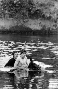 Into the River Eden for a wash for this horse and two bareback riders at the Appleby Into the River Eden for a wash for this horse and two bareback riders at the Appleby