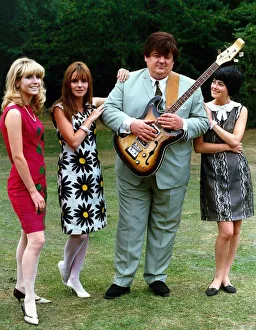 Robbie Coltrane actor standing with three women holding guitar Robbie Coltrane actor standing with three women holding guitar