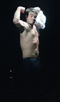Robbie Williams in concert SECC Glasgow February 1999 takes of shirt shows off bare chest Robbie Williams in concert SECC Glasgow February 1999 takes of shirt shows off bare chest