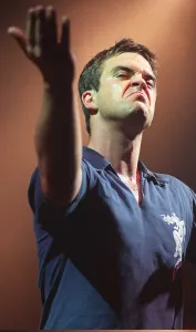 Robbie Williams makes a face to the audience at his concert at the SECC Glasgow February Robbie Williams makes a face to the audience at his concert at the SECC Glasgow February