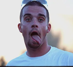 Robbie Williams sticking his tongue out to photographers at T in The Park festival Robbie Williams sticking his tongue out to photographers at T in The Park festival