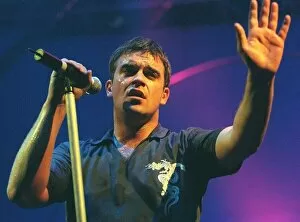Images Dated 10th February 1999: Robbie Williams waves to the audience at his concert in Aberdeen. February 1999