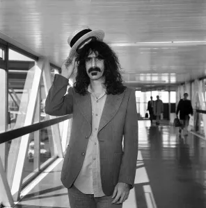 Rock Star Frank Zappa complete with straw boater hat at London's Heathrow airport Rock Star Frank Zappa complete with straw boater hat at London's Heathrow airport
