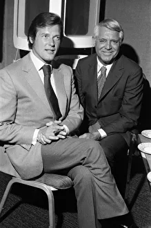 Roger Moore and Cary Grant sample one of their perfumes during their visit to their Roger Moore and Cary Grant sample one of their perfumes during their visit to their