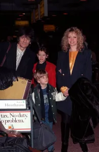 Ronnie Wood and family arriving at Heathrow airport in February 1990 Ronnie Wood and family arriving at Heathrow airport in February 1990