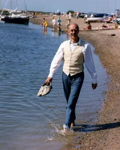 Roy Marsden actor walking along beach paddling in water Roy Marsden actor walking along beach paddling in water