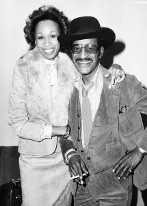 Sammy Davis Jnr Actor/Singer Arriving at heathrow with wife November 1980 Sammy Davis Jnr Actor/Singer Arriving at heathrow with wife November 1980