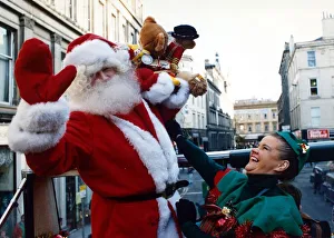 Santa Claus with one of his little elf helpers pictured in Glasgow December 1991 Santa Claus with one of his little elf helpers pictured in Glasgow December 1991
