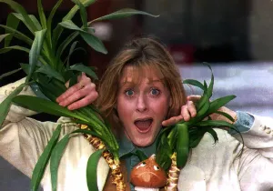 Sarah Lancashire actress poking her head through a plant Sarah Lancashire actress poking her head through a plant