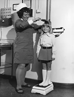 School nurse seen here measuring and weighing a pupil. 25th August 1972 School nurse seen here measuring and weighing a pupil. 25th August 1972