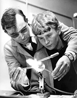 A scientific glass blower, Mr. Keith Hartley, instructs 17 year old Arthur Burdon in A scientific glass blower, Mr. Keith Hartley, instructs 17 year old Arthur Burdon in