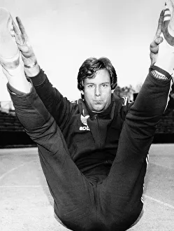 Scottish athlete and track star David Jenkins sitting back with legs in the air touching Scottish athlete and track star David Jenkins sitting back with legs in the air touching