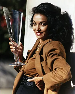 Shakira Caine wife of actor Michael Caine holding a long glass Shakira Caine wife of actor Michael Caine holding a long glass