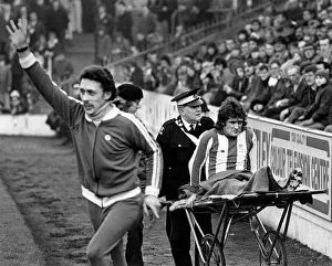 Sheffield Wednesday's Colin Harvey is wheeled off in pain Sheffield Wednesday's Colin Harvey is wheeled off in pain