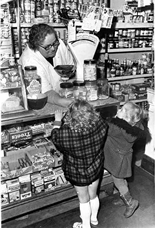 A shopkeeper serves children sweets at their local corner shop in Cardiff May 1977 A shopkeeper serves children sweets at their local corner shop in Cardiff May 1977