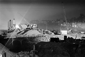 Silent cranes reach over what is usually a scene of intense activity by day - the site of Silent cranes reach over what is usually a scene of intense activity by day - the site of
