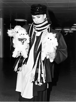 Singer Boy George arrives at Heathrow airport carrying two furry toy animals wearing Singer Boy George arrives at Heathrow airport carrying two furry toy animals wearing