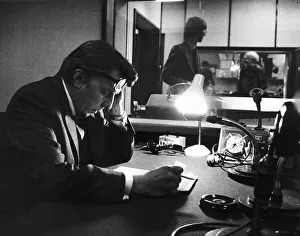 Sir Robin Day TV Presenter and Broadcaster sits in a radio studio studying his script Sir Robin Day TV Presenter and Broadcaster sits in a radio studio studying his script