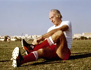 Sir Stanley Matthews puts on his football boots before taking part in agame in Malta Sir Stanley Matthews puts on his football boots before taking part in agame in Malta
