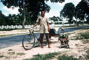 Sleeping child and bicycle rickshaw driver near Angkor Wat North West Kampuchea Cambodia Sleeping child and bicycle rickshaw driver near Angkor Wat North West Kampuchea Cambodia
