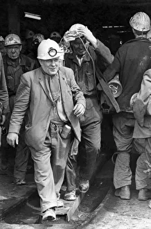 A smiling miner makes his way to the surface cage after his shift A smiling miner makes his way to the surface cage after his shift