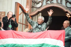 South African President Nelson Mandela waving to the crowds from the balcony of South South African President Nelson Mandela waving to the crowds from the balcony of South