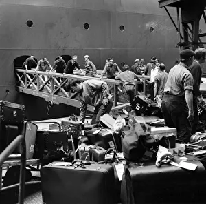 Southampton Docks: Shore and office staff of Cunard, loading baggage onto Q.E Southampton Docks: Shore and office staff of Cunard, loading baggage onto Q.E