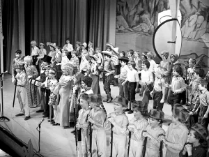 The stage is full of children during a performance by scouts The stage is full of children during a performance by scouts