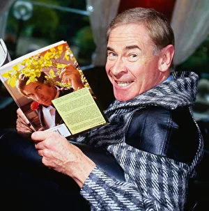 Stanley Baxter holding book with picture of himself on it September 1986 Stanley Baxter holding book with picture of himself on it September 1986