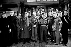 Stars of the popular wartime comedy television programme Dads Army toast pose for a group Stars of the popular wartime comedy television programme Dads Army toast pose for a group