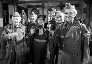 Stars of the popular wartime comedy television programme Dads Army toast each other after Stars of the popular wartime comedy television programme Dads Army toast each other after